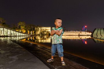 little boy playing in guangzhou at night