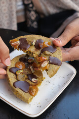  hand breaking cookies with nuts and chocolate 