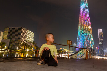 little boy playing in guangzhou at night