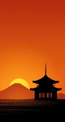 Silhouetted pagoda at sunset over a mountain range