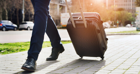 Legs, suitcase and walking with businessman in city for commute, journey or travel to location....