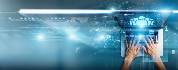 The sales manager is using a laptop with CRM data on customer interactions, sales pipelines, lead tracking, personalized engagement, performance dashboards, and relationship management tools.