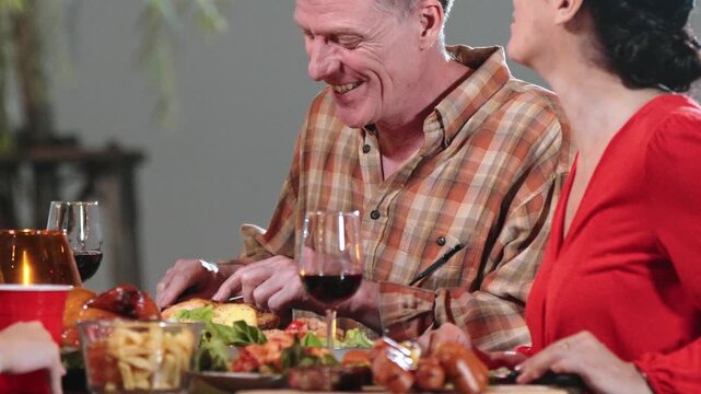 Old couple celebrate holiday in garden. Retirement age senior having dinner. Outdoor camping activity to relax, share tasty food and spend time with lovely couple strengthen family bond. Divergence. - Powered by Adobe