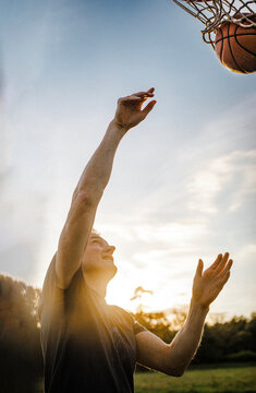 A man threw a basketball into the hoop