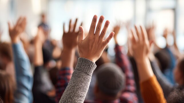 Hands raised in a meeting