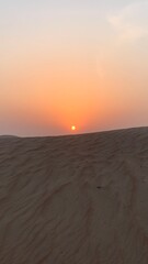 HD close-up of desert sand, revealing fine golden grains and natural ripples shaped by the wind. A detailed and textured view capturing the essence of arid landscapes.