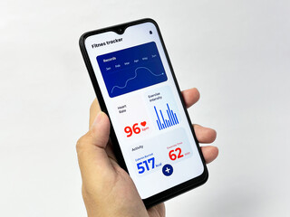 A hand holds a smartphone displaying a fitness tracker app, showing workout data - isolated on white background