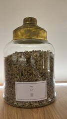 glass jar with spices on white background A large glass jar filled with aromatic wood shavings, surrounded by shelves of spices and herbs A composition of many different spices and herbs standing in a