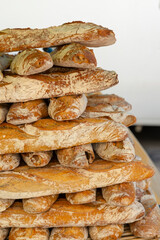 Freshly baked baguettes forming a tempting pyramid at a French market in Nyons