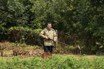Hunter in camouflage jacket with antique double-barreled shotgun