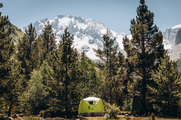green tent in the forest at the foot of the Ullu-Tau mountain Kabardino-Balkaria. Tent among the mountains. Panorama of the ideal landscape
