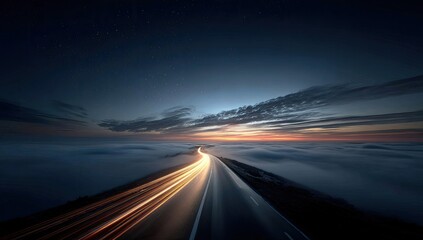 Fototapeta premium Highway through a sea of clouds at dawn. Stars visible. Long exposure lights