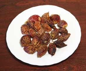 A pile of fruit pits on a white plate