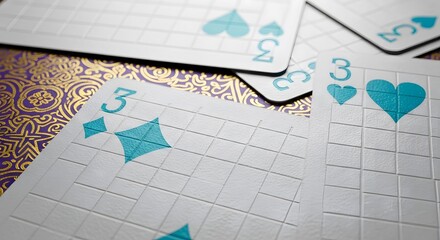 Close-up view of playing cards, showcasing the number three and suit symbols.