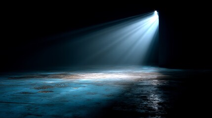 A beam of light shining on an empty stage with blue tones