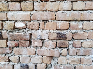 Old rustic brick wall texture with cement.