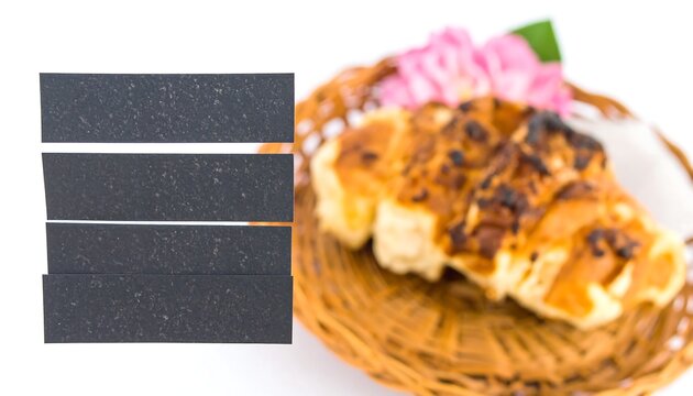 Three dark rectangular placeholders over a blurred image of a pastry in a basket with pink flowers