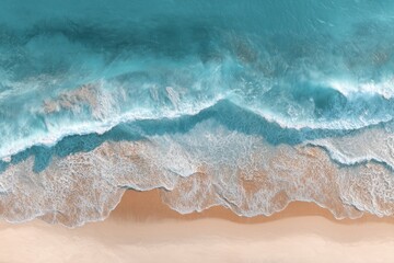 High-angle view of turquoise waves crashing on a light beige beach