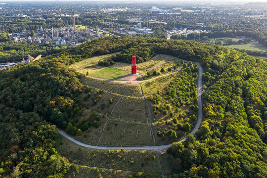 Aerial view of Das Geleucht memorial of Ruhr region contrasting against the green landscape, with industrial structures visible in the background, Moers, North Rhine-Westphalia, Germany.