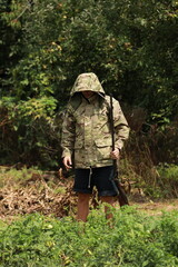 Hunter in camouflage jacket with antique double-barreled shotgun