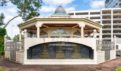 Raja Ayang Mausoleum, a beige octagonal shrine with a dome and inscribed black plaque, in Bandar...