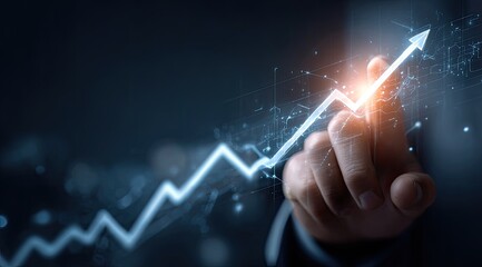 Hand pointing at a glowing upward trending graph