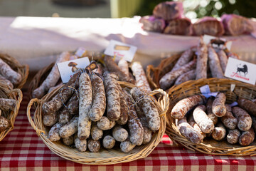 French sausages displayed in wicker baskets at farmers market in Nyons, France