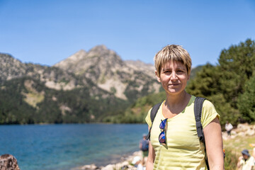Female hiker admiring the stunning landscape of lake san maurici, a popular destination in the aiguestortes i estany de sant maurici national park, catalonia, pyrenees