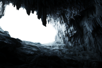 Dark cave opening with icy stalactites and rock isolated on a transparent background