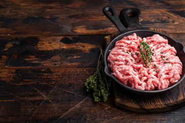 Ready for cooking raw ground pork and beef meat, fresh mince meat in skillet. wooden background. top view