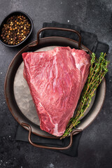 Raw Wild Boar meat, fresh Game Meat. black background. top view