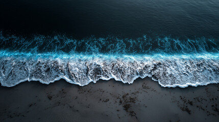 Aerial photo, drone capture of bioluminescent waves glowing electric blue as they lap against a black volcanic sand beach, hypnotic contrast and texture, taken at night with moonli