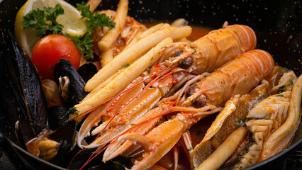 cooked shrimps ina. soup on a table in a pan 