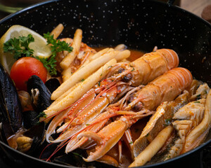 cooked shrimps ina. soup on a table in a pan 