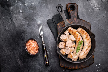 Fried BBQ Sausages with pork and beef meat  in pan. black background. top view