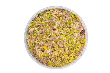 Turkish Halva with tahini and pistachio isolated on a white background. top view