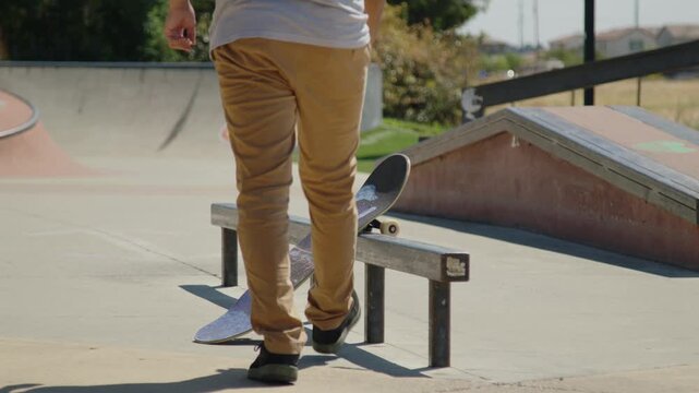 A skateboarder jogs up to grab their board resting on a rail, then quickly hops on and pushes away - Powered by Adobe