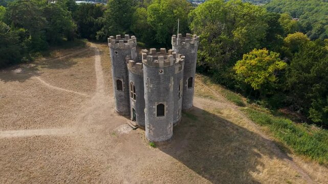 Aerial drone rotation at Blaise Castle, Bristol. Starting level with the turrets, the drone moves upward and right, revealing a sweeping shadow extending beside the castle for a striking visual effect