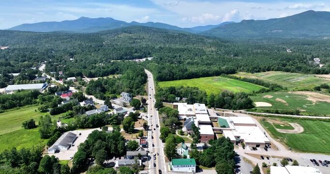 Drone view of Conway, New Hampshire and the Kancamagus highway with the White Mountains in the distance