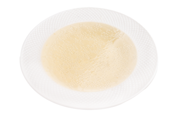 Bowl of chicken broth isolated on white background. top view