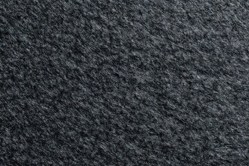 Fototapeta premium Close-up of a rough, dark gray material; short, irregular fibers give a textured, slightly chaotic appearance