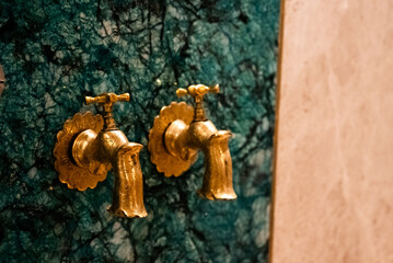Golden Faucet Detail in Luxury Spa Interior – Wellness and Relaxation Theme
