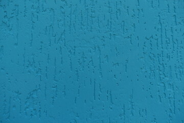 turquoise blue wall with stucco worm finish texture