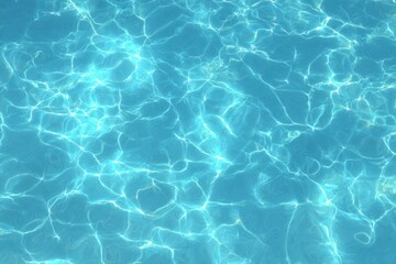 Obraz premium Shimmering azure water with sun-dappled light playing across the surface, creating an abstract and serene pattern