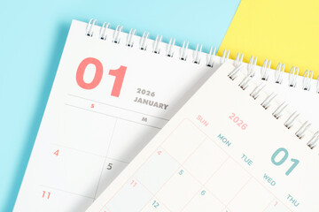 January 2026 calendars close-up on yellow and blue background, planning concept.