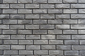 Background - brick veneer wall with stretcher bond pattern in shades of gray