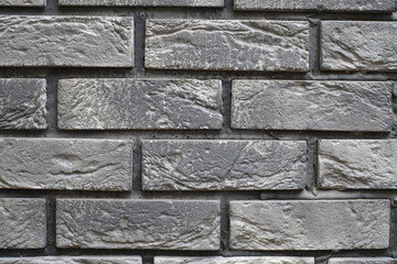 Closeup of brick veneer wall with stretcher bond pattern in shades of gray