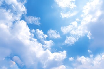 Brilliant blue sky with fluffy white clouds, sunshine gleaming from upper right. Airy, peaceful, and bright