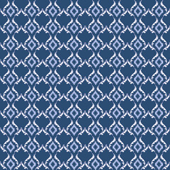  A traditional indigo pattern featuring a white intricate diamond motif with delicate, flowing curves.