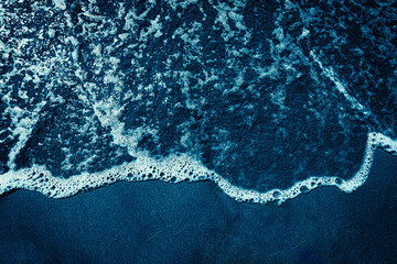 Navy blue wave on sand beach 